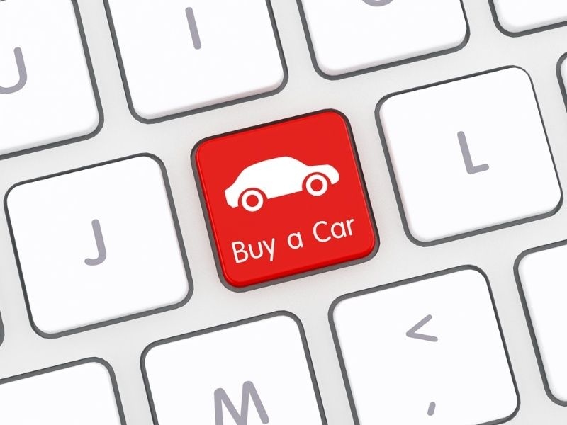 Computer keyboard with a red ‘Buy a Car’ key featuring a car icon.