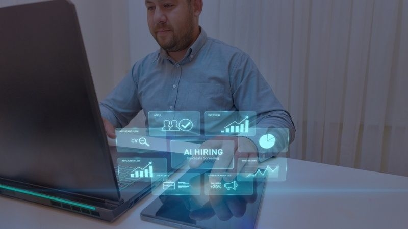 Person using a laptop with digital overlay illustrating AI hiring and candidate screening process.