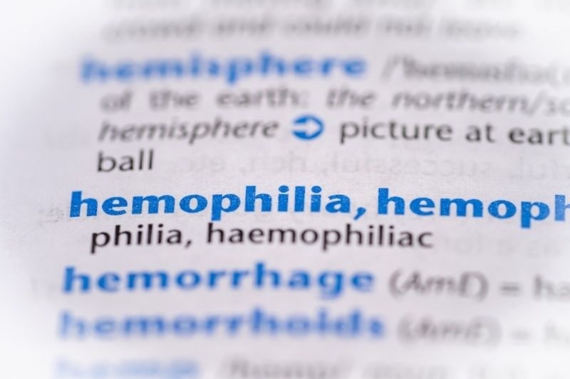 Close-up of the word ‘hemophilia’ highlighted in a medical dictionary or textbook.