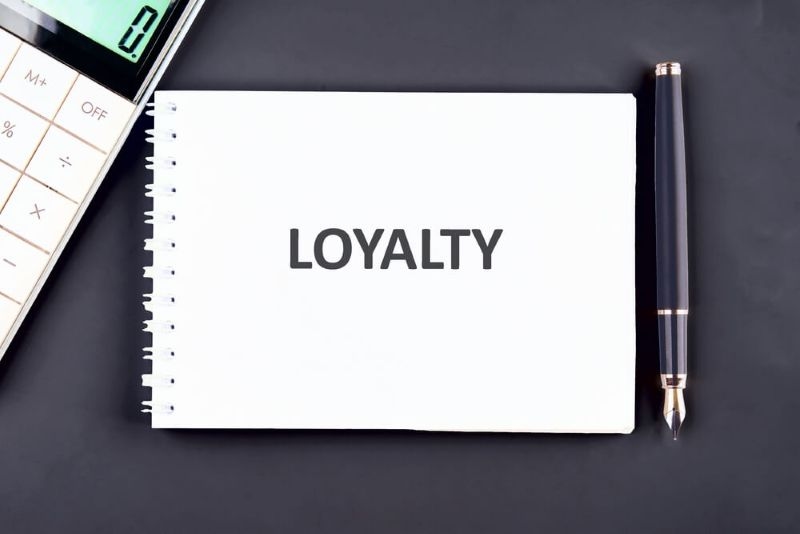 Text Loyalty written on a notepad with pen on side 