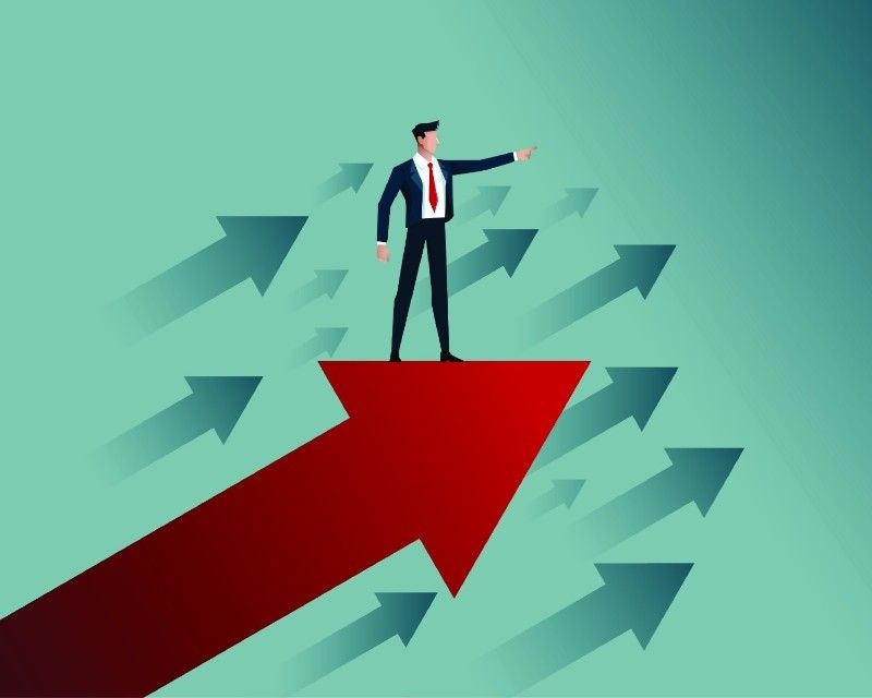 A man standing on big red arrow pointing finger to move forward