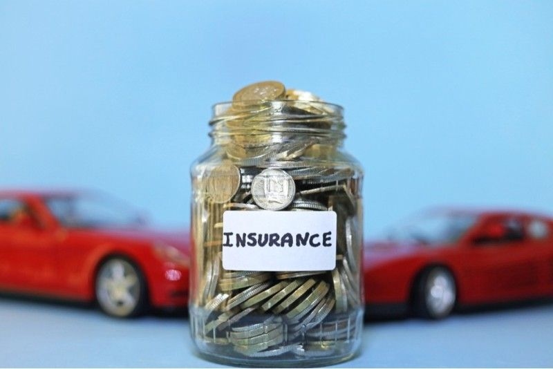 A Glass Jar Full Of Money Labelled Insurance.