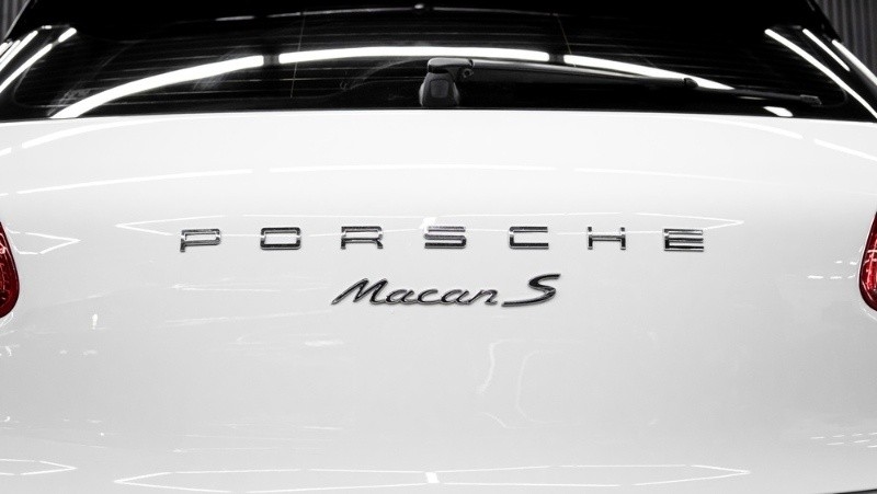 Close-up of the rear branding on a white Porsche Macan S car.