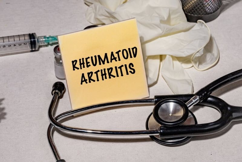 Text rheumatoid arthritis on a paper with stethoscope on side
