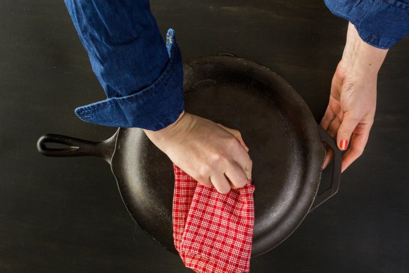 Traditional cast iron skillet on black wood table