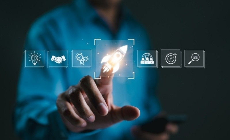 A hand touching rocket icon on digital interface, symbolizing business growth, startup success, innovation, and achieving goals through strategic planning.