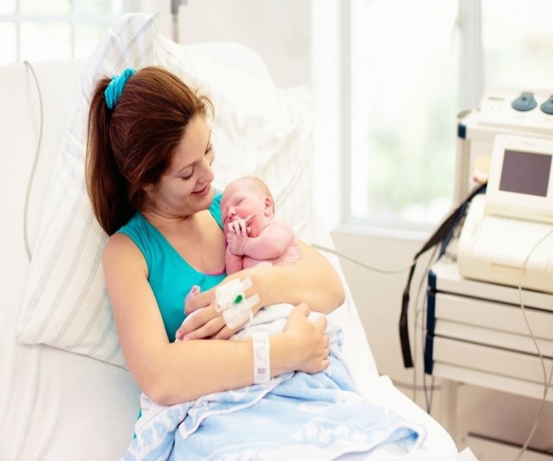 Mom holding her new born child after labor. 