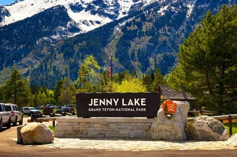 Entrance sign for Jenny Lake in Grand Teton National Park with mountains in the background.