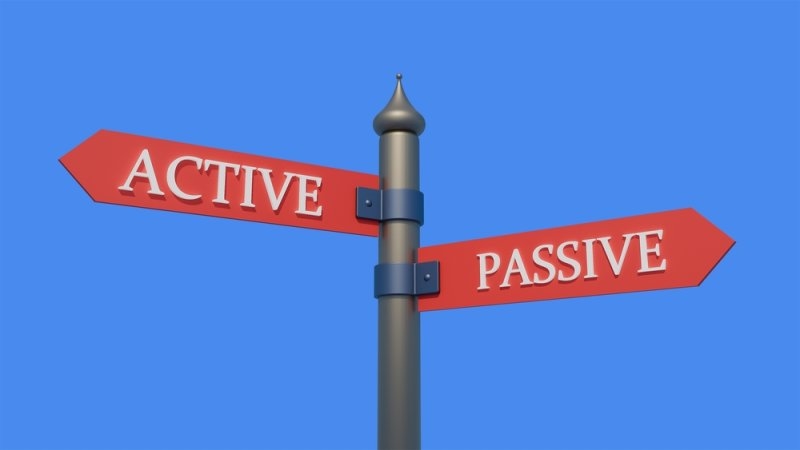 ACTIVE VS PASSIVE written on the signpost.