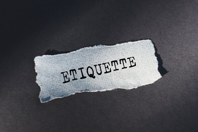 Torn Piece of Paper With the Word Etiquette.