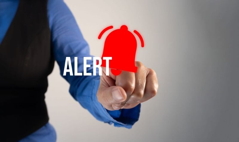 person pointing at a notification bell and the word 