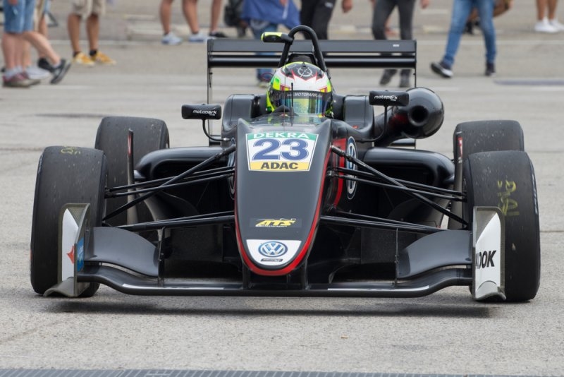 Young racing driver competing in a junior formula racing series