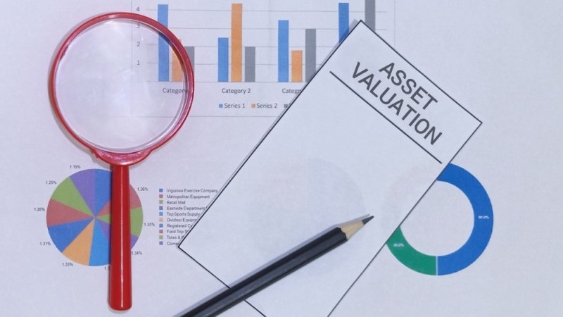 Delve into asset valuation using charts and a magnifier, perfect for insightful analysis. A powerful tool for investment strategies and financial planning.