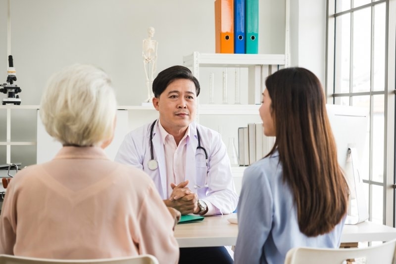Doctor discussing care options with a patient and caregiver.
