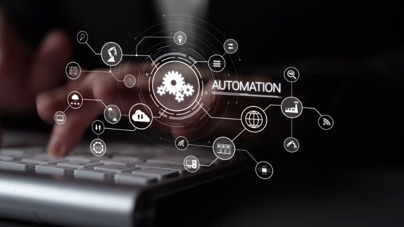 **Alt text:** Business automation concept with digital workflow icons, gears, and connected technology interface above a computer keyboard.