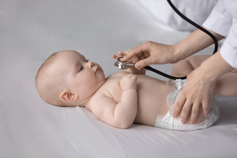 nurse using stethoscope at regular checkup