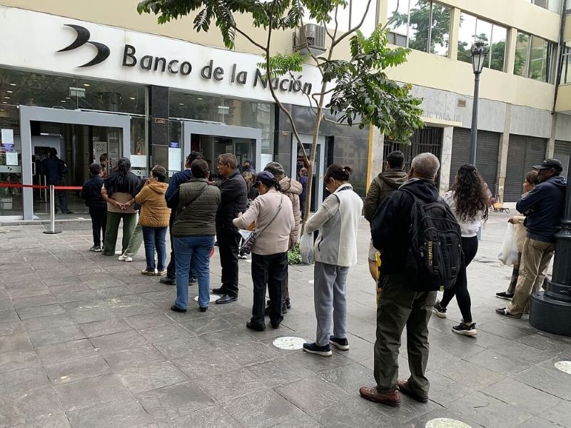Peruvian clients queuing outside a branch of Banco de la Nacion