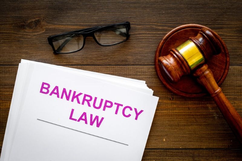 Text bankruptcy law on a paper with gavel on side
