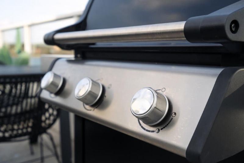temperature control knobs close up of a barbeque grill