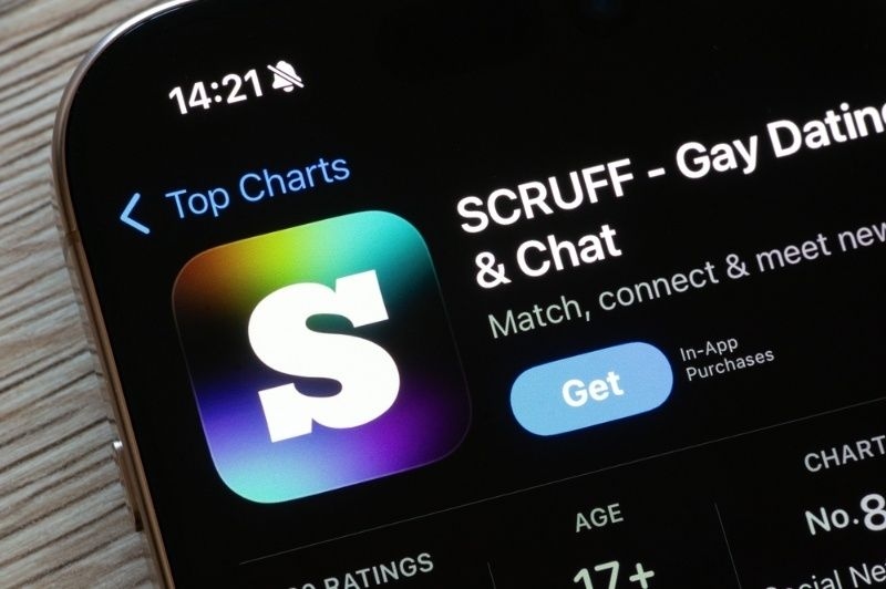 Smartphone screen displaying the SCRUFF gay dating and chat app listing in the app store.