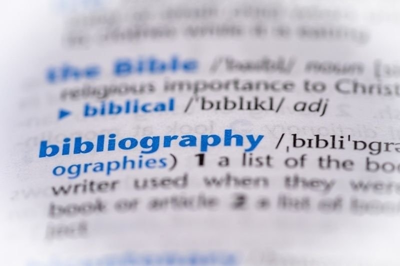 A close-up dictionary page shows the word “bibliography” highlighted in blue.