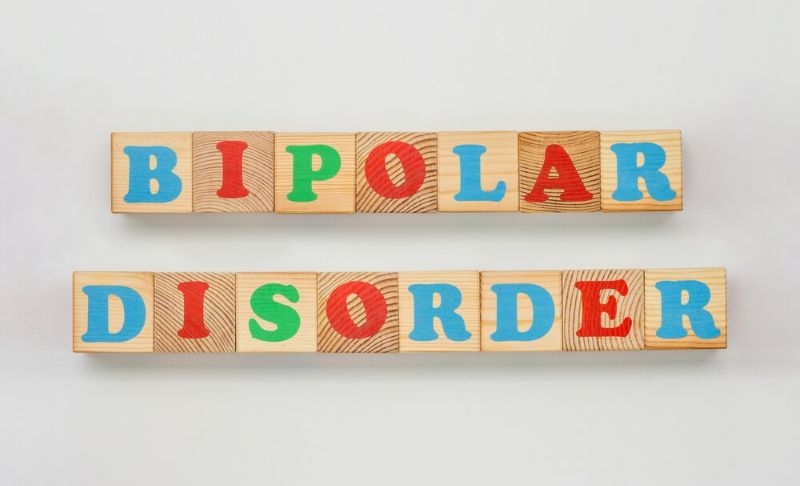 Text bipolar disorder on wooden blocks with colorful alphabets