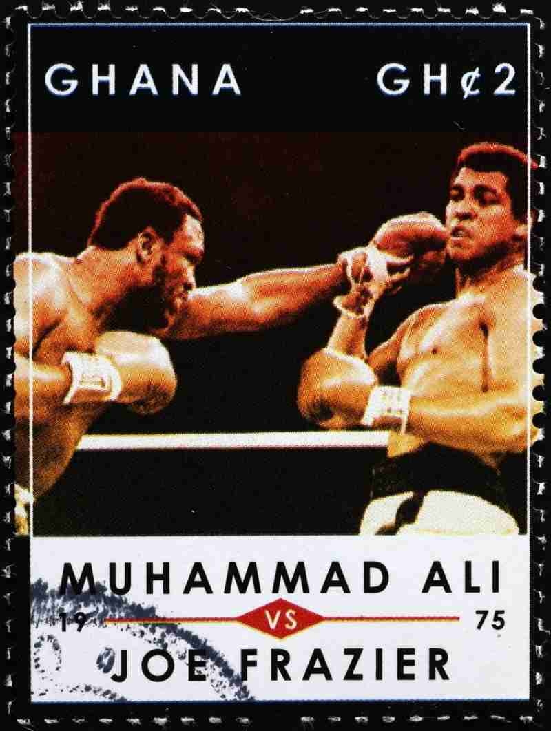 Vintage postage stamp featuring Muhammad Ali punching Joe Frazier during a boxing match.
