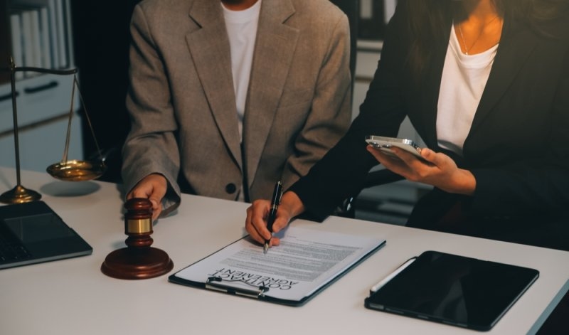 Lawyer, legal advisor, businessman brainstorming information on a table