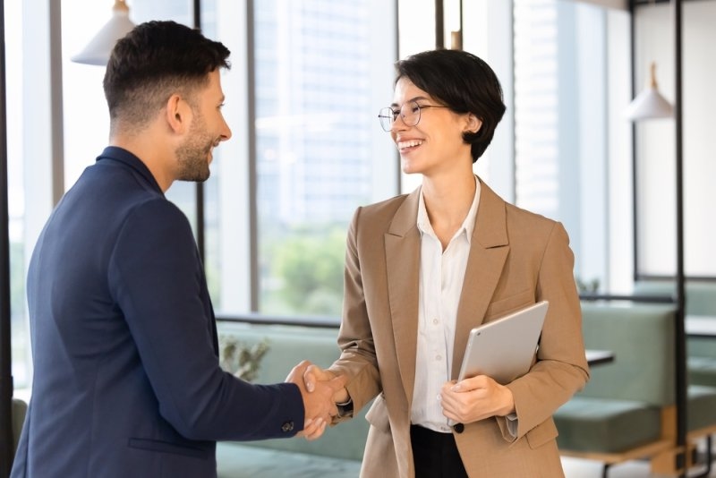 businesspeople shaking hands after business meeting