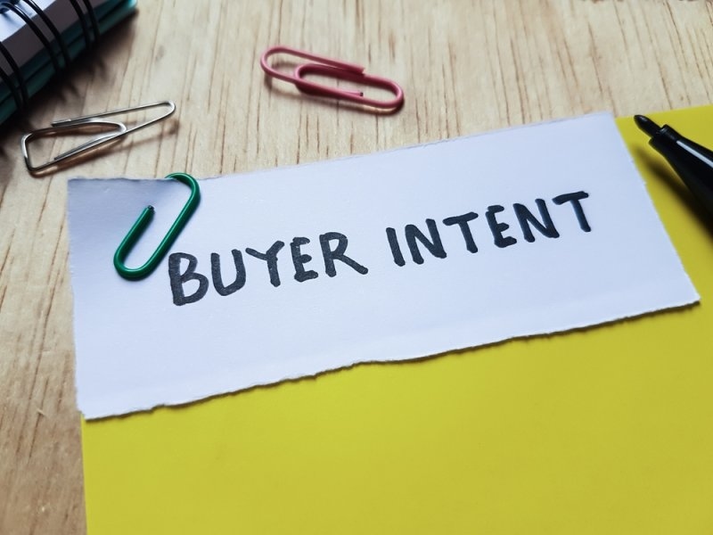 Buyer intent text on a paper clipped to a yellow paper