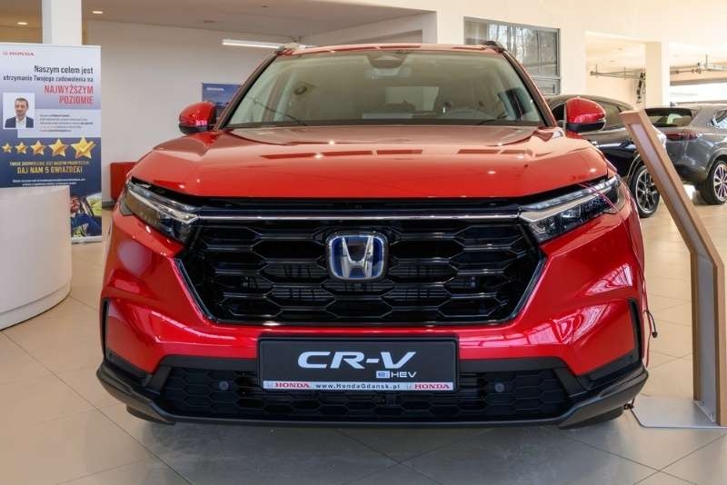 Front view of a red Honda CR-V displayed inside a car showroom.