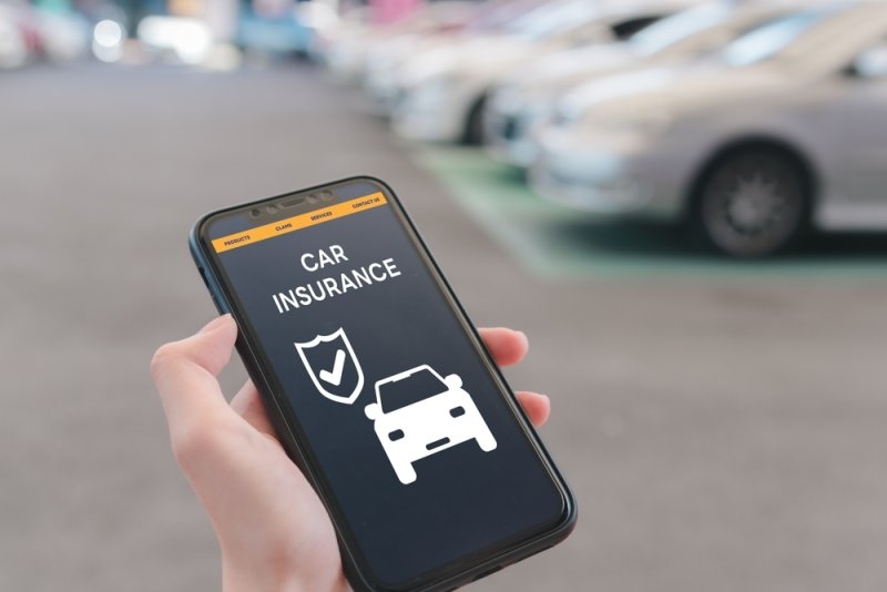 Close-up of a smartphone showing a car insurance application