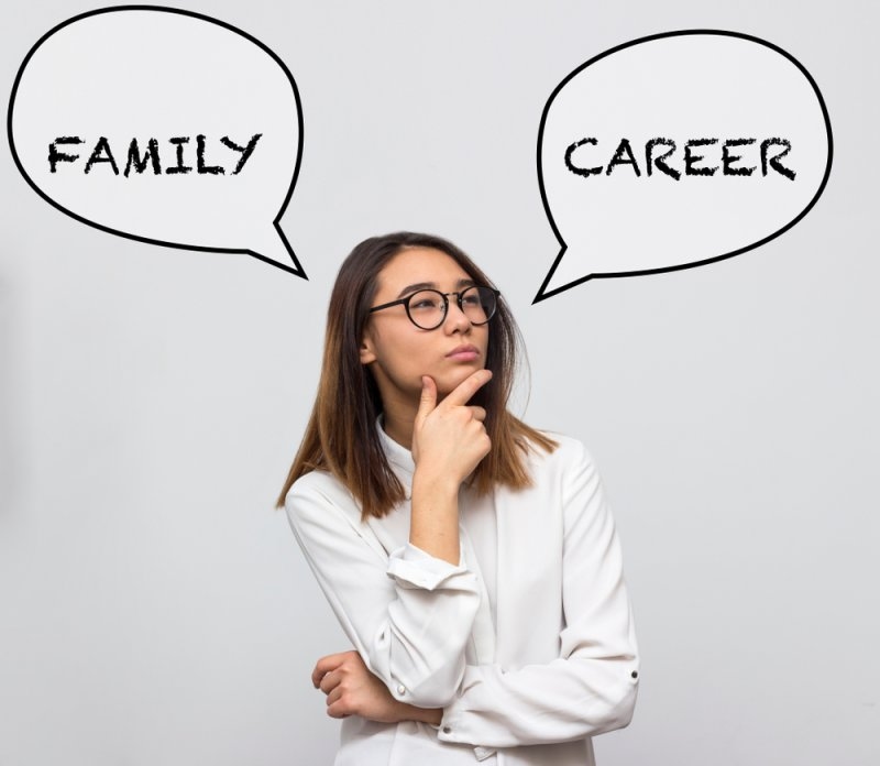 Young pretty asian woman thinking about choice between hard work and happy family.