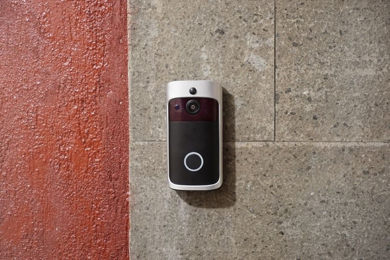 modern surveillance camera is installed on a front door