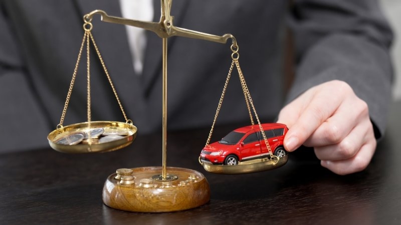 a car model and coins on a scale