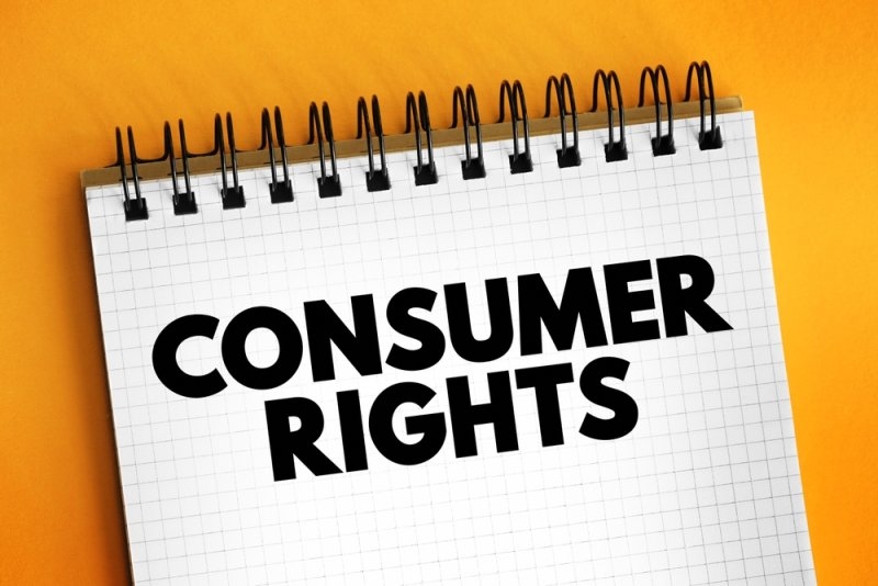 Spiral notebook displaying the words “CONSUMER RIGHTS” in bold black text against an orange background.