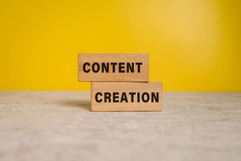 Text content creation on wooden block stacked 