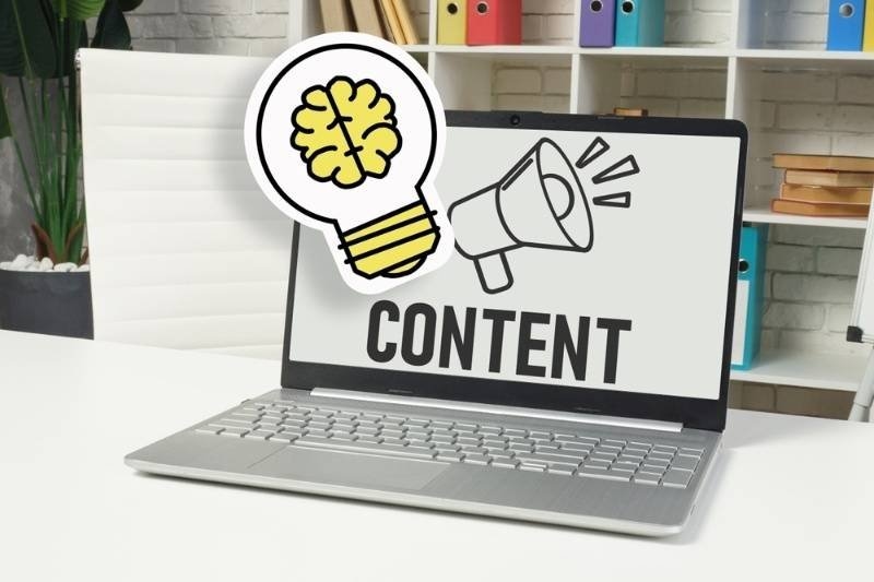 Laptop displaying the word “Content” with lightbulb and megaphone icons representing content creation and promotion.