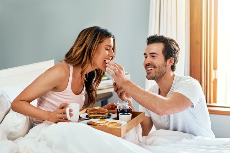 a couple having breakfast together on a staycation honeymoon