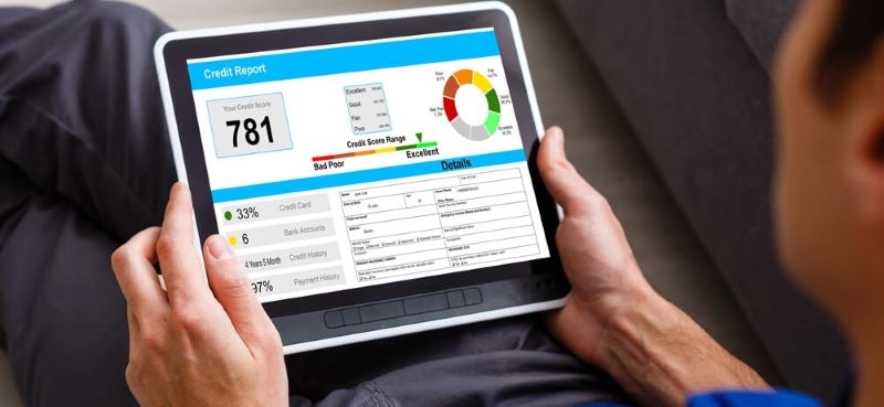 Man looking at his credit score on a tablet screen