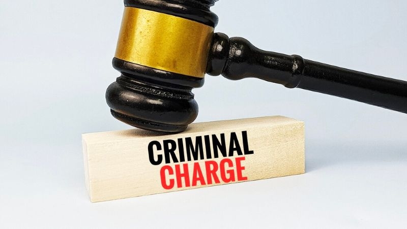 Judge gavel on wooden block with text criminal charge representing law enforcement prosecution legal offense court trial justice system and penalty concept