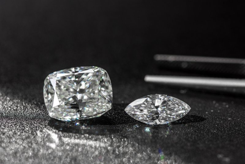 Cushion cut and princess cut diamond engagement rings side by side