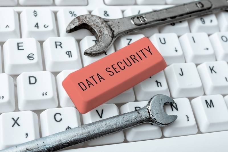 Computer keyboard with tools and an eraser labeled ‘Data Security,’ symbolizing cybersecurity maintenance.