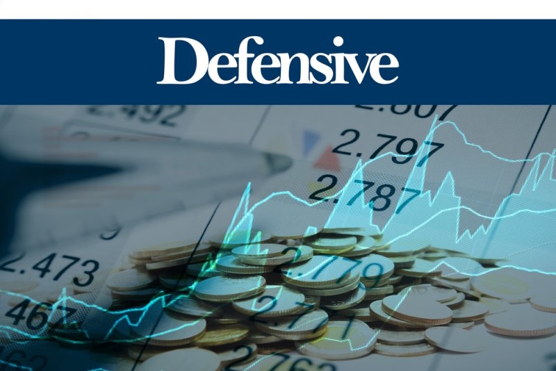 Financial graphic with coins, stock market figures, and a blue “Defensive” banner representing defensive investments.