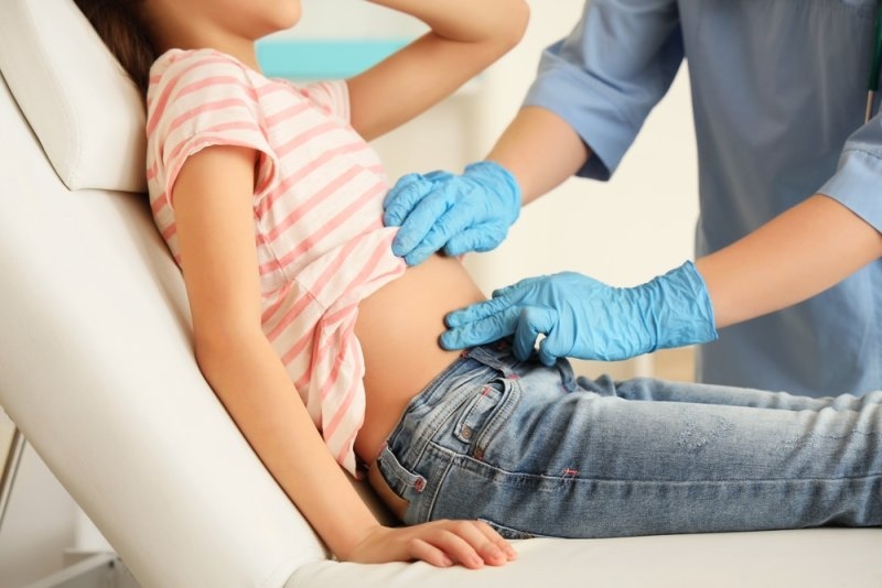 doctor examining teenage girl