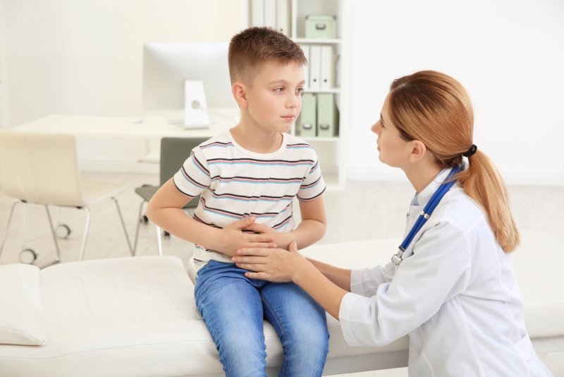 Doctor working with little patient in hospital