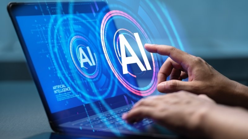 Person interacting with an AI interface displayed on a laptop screen.
