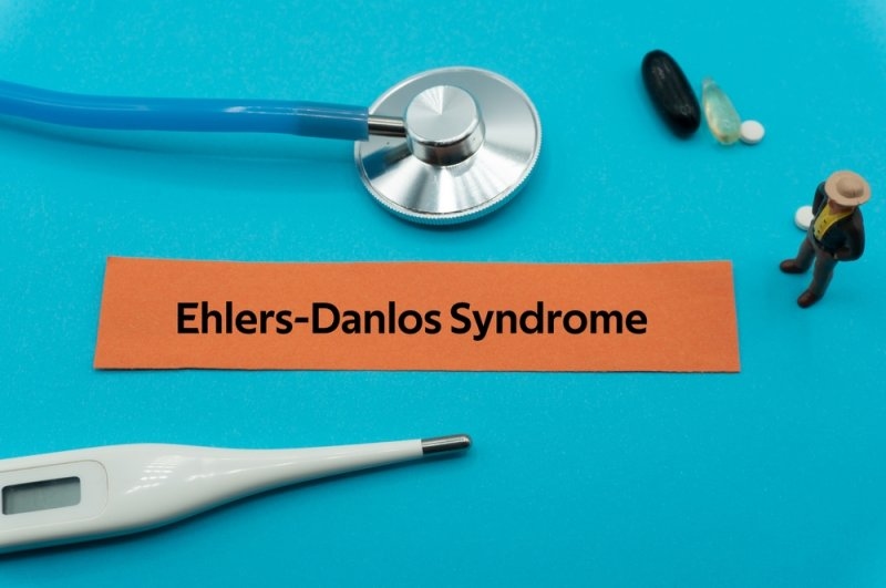 Medical-themed display featuring an Ehlers-Danlos syndrome label, stethoscope, thermometer, and pills.