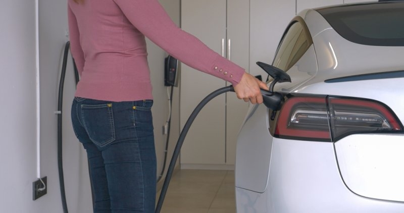 woman charging her ev at home
