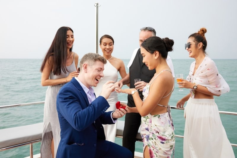 man showing engagement ring and surprise his girlfriend